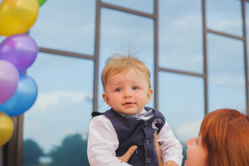 portrait of a little boy mom holds in her arms