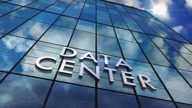 Data center on glass building. Mirrored sky and city modern facade. Server, cloud, computer network, computing, database and internet technology concept seamless and loopable 3D rendering animation.