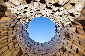view from the bottom of a wooden well