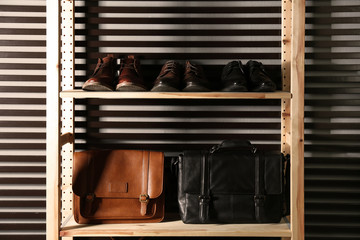 Plakat Wooden shelving unit with different leather shoes and bags