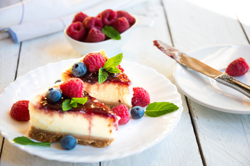 Homemade delicious cheesecake with fresh fruit and mint
