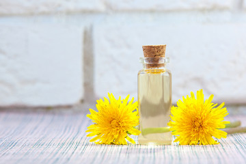 dandelion essential oil in  beautiful bottle on table © solstizia