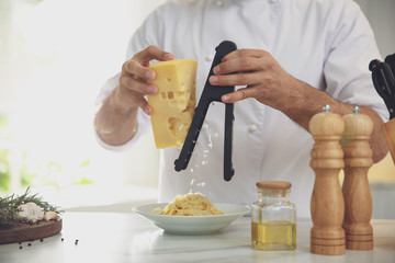 Chef cooking at table in kitchen, closeup