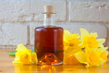 Essence of flowers  on white in beautiful glass jar