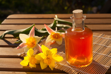 Essence of flowers  on white in beautiful glass jar