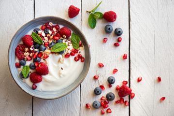 Yogurt with fresh fruit and cereals in a bowl, healthy breakfast