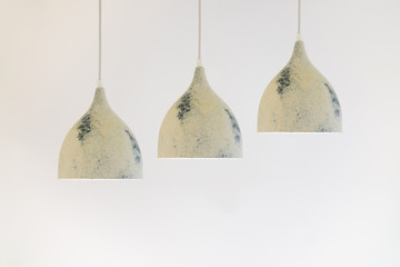 three ceiling lights on a long wire hanging from the ceiling on a white background