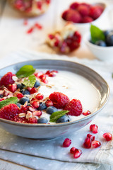Yogurt with fresh fruit and cereals in a bowl, healthy breakfast