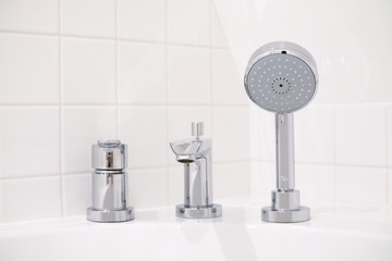 shower head with washbasin faucet in bathroom