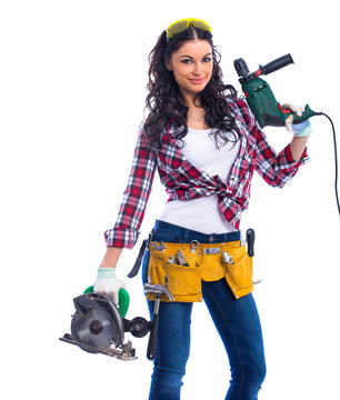 Sexy brunette woman mechanic with circular saw and perforator