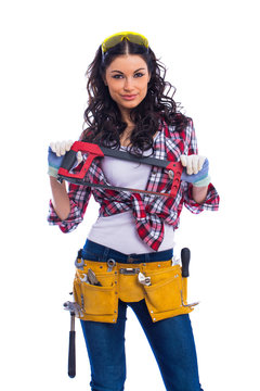 Sexy brunette woman mechanic with a wrench