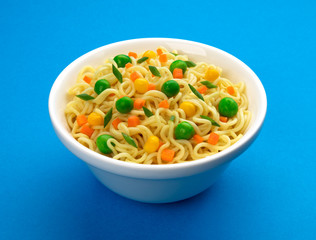 Bowl of instant noodles isolated on blue background