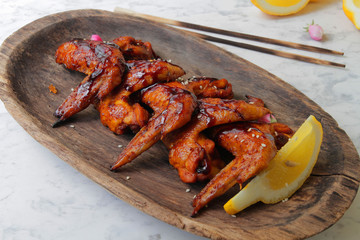 
fried chicken wings in soy sauce with spices and herbs. Fast food, grilled chicken wings. Food delivery.