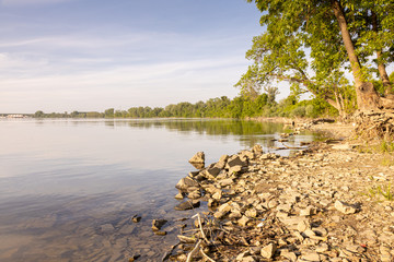 Sunny spring day on Danube river beach with beautiful blue cloudy sky and copy space