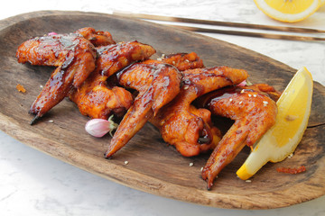 
fried chicken wings in soy sauce with spices and herbs. Fast food, grilled chicken wings. Food delivery.