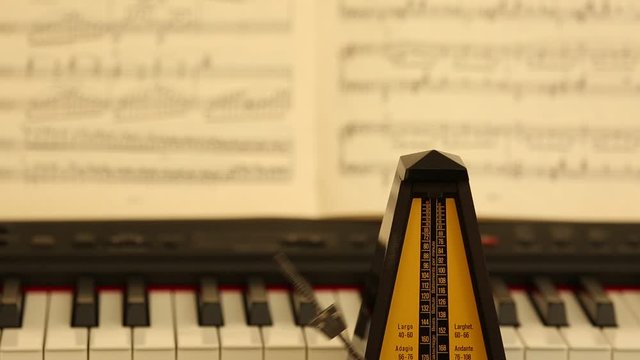 metronome, piano and musical notes