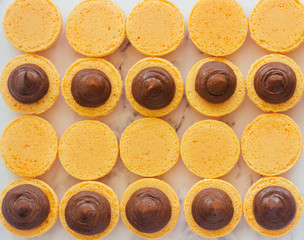 Macaroons. Delicious french desserts. Macaroons with chocolate and orange. Macaroons on the table