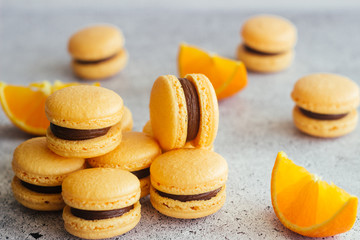 Fototapeta na wymiar Macaroons. Delicious french desserts. Macaroons with chocolate and orange. Macaroons on the table