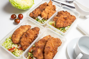 Set of lunch boxes with rice, salad and fried chicken