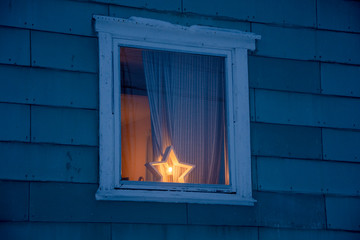 cold window with burning candles