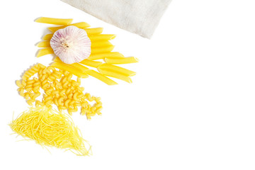 Different types of pasta laid on a light background. Healthy eating, Italian traditional kitchen concept.