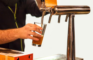 Man drawing beer from tap