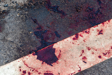 Blood clots on the side of an asphalt road