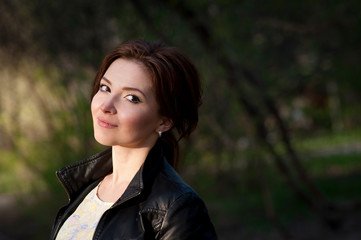 Portrait of a beautiful brunette with a smile. Close up. Warm tone