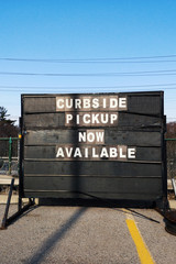 Sign with message announcement that contactell curbside pickup available during coronavirus epidemic. Shopping curb side pick up during social distance quarantine of a covid-19 virus. © anoushkatoronto