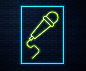 Glowing neon line Microphone icon isolated on brick wall background. On air radio mic microphone. Speaker sign. Vector Illustration