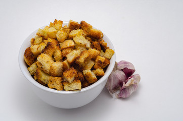 Tasty crackers in a white cup on a white background
