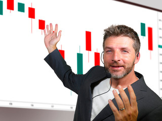 confident successful trader man with headset speaking at event coaching trading business at...