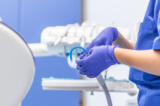 European Medical Health Care System. Public Clinic, Macro Shot Of A Dental Assistant Helping With Saliva Ejector And Sucker During Dentist Treatment. Commercial Use, Copy Space.