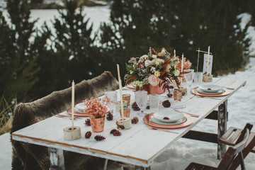 Close up of romantic wedding table in the middle of the mountain. Winter wedding decor.