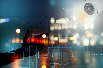 Multiple exposure of man, cctv camera and night city