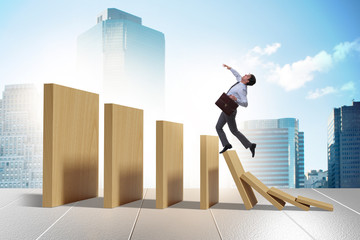 Businessman in domino effect concept