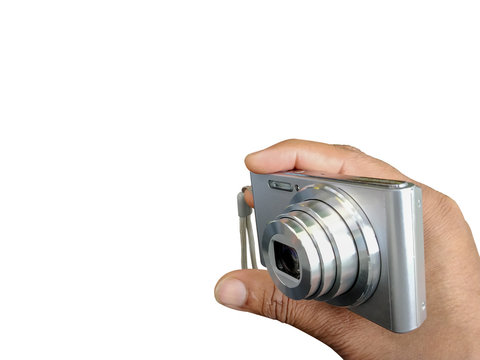 Digital Point and shoot camera in hand to clicking picture isolated on white background