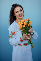 girl in a long dress with flowers on the background of a career lake