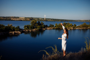 girl in a long dress on a background of water, lake career