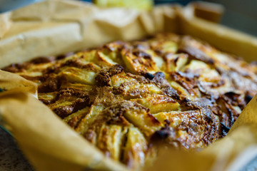 homemade fresh apple pie in baking tray with baking paper in it