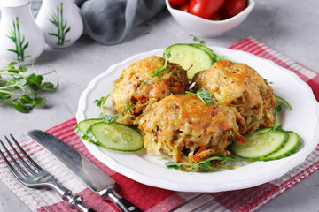 Beef cutlets with potatoes served with cucumber and peas microgrines on a white plate on a gray concrete background, Closeup, Horizontal format