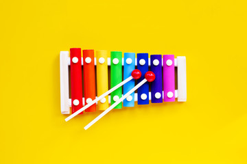 Colorful xylophone on yellow background.