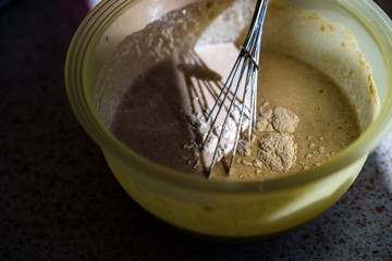 mixing wholemeal homemade vegan bread in plastic bowl