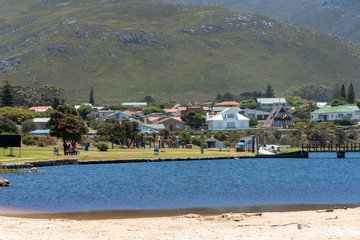 Kleinmond, Western Cape, South Africa. 2019, Saltwater lagoon overlookd by holiday homes and...