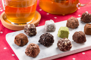 Variety chocolate truffles and earl grey tea.
