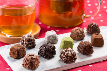 Variety chocolate truffles and earl grey tea.