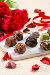 Variety chocolate truffles and rose