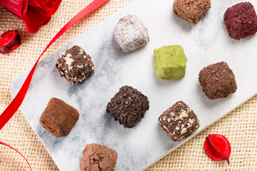 Variety chocolate truffles and rose