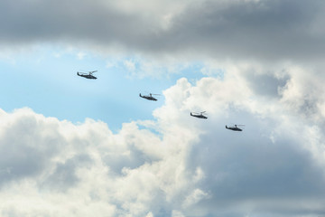 From bellow Group military helicopters in the sky
