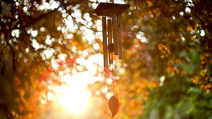 Stunning sunset backlighting slow motion wind chime in temple garden - Powered by Adobe